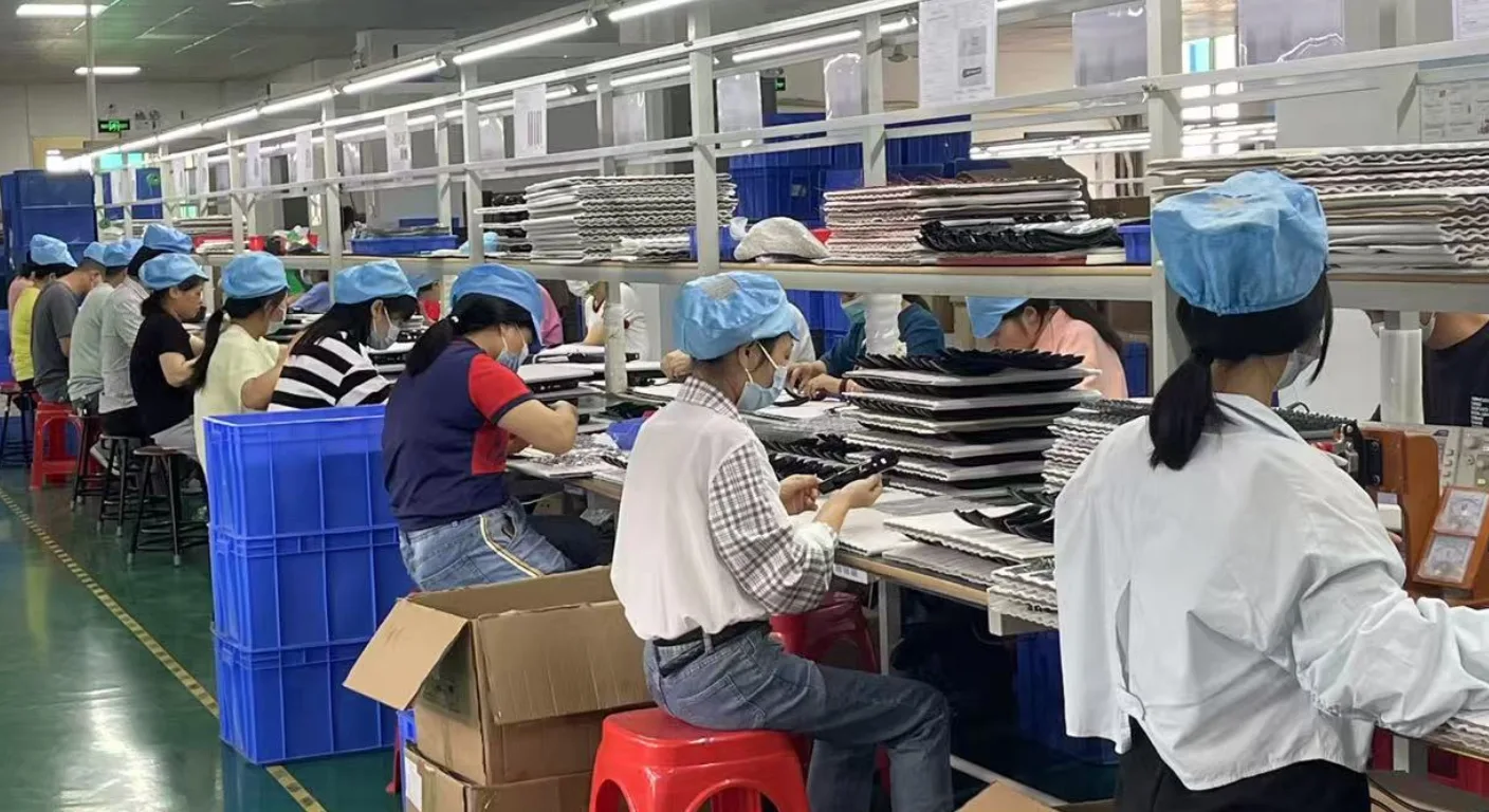 Red light therapy device manufacturing production line with workers assembling LED therapy products