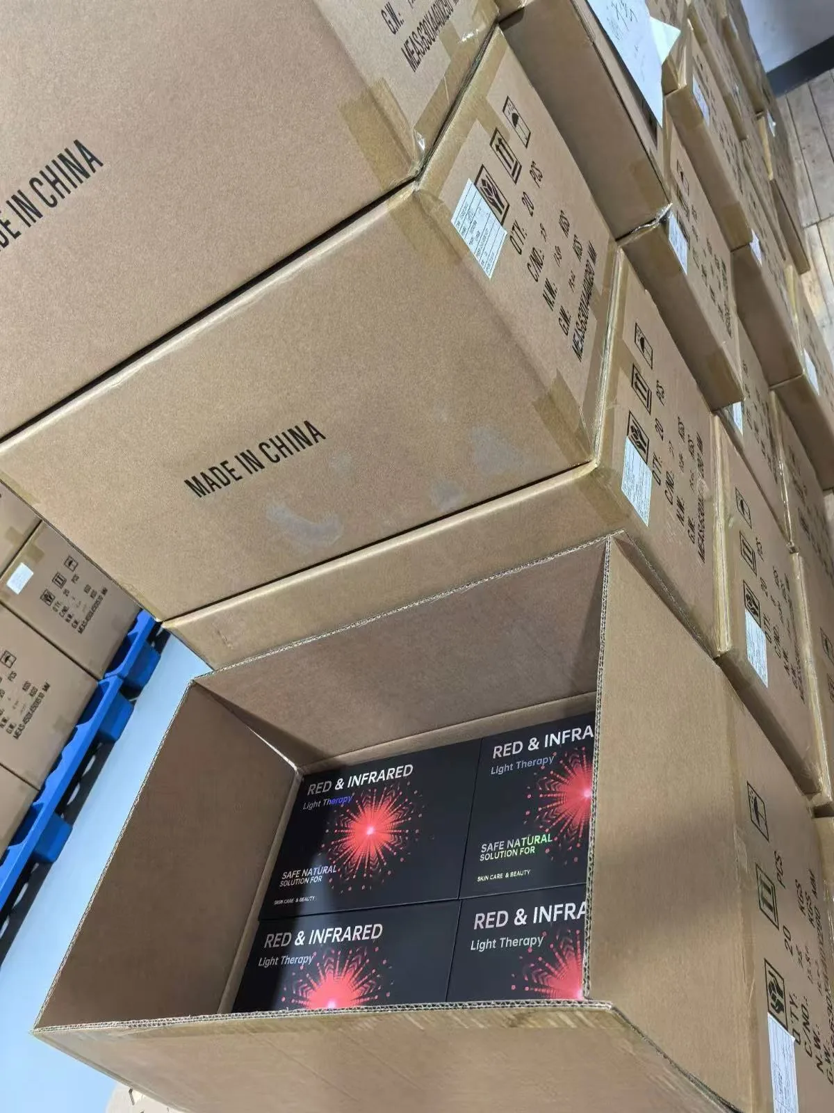 U.S. Wellness Retailer: Six Orders in Two Years 1 Opened shipping cartons with red and near-infrared light therapy product boxes